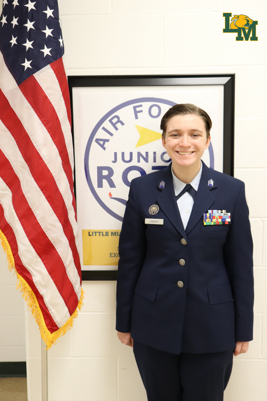Cadet Marina Lindsey smiles in front of American flag